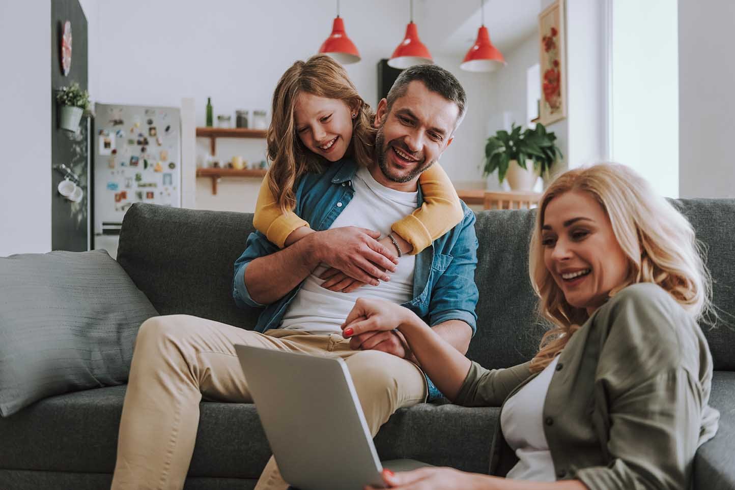 Happy family watching videos on laptop at home